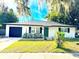 Charming ranch home with white brick exterior, black accents, and a green door at 4732 Lighthouse Cir, Orlando, FL 32808