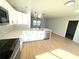 Sleek kitchen with white cabinets, quartz countertops, and stainless steel appliances at 4732 Lighthouse Cir, Orlando, FL 32808