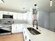 Modern kitchen with white cabinets, quartz countertops and a stylish faucet at 4732 Lighthouse Cir, Orlando, FL 32808