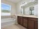 Double vanity bathroom with soaking tub and separate shower at 4838 Southlawn Ave, Orlando, FL 32811