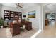 Bright home office with built-in bookshelves, a large desk, and a comfortable rug at 4838 Southlawn Ave, Orlando, FL 32811