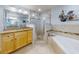 Spacious bathroom with a large soaking tub, shower, and double vanity at 5 Riverwalk Dr # 503, New Smyrna Beach, FL 32169