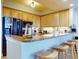 Modern kitchen with breakfast bar, stainless steel appliances, and light wood cabinets at 5 Riverwalk Dr # 503, New Smyrna Beach, FL 32169