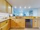 Kitchen features granite countertops, stainless steel dishwasher, and light wood cabinets at 5 Riverwalk Dr # 503, New Smyrna Beach, FL 32169
