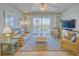 Spacious living room with leather couch, wicker chairs, and scenic views at 5 Riverwalk Dr # 503, New Smyrna Beach, FL 32169