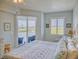 Main bedroom with king bed, dresser, and balcony access at 5 Riverwalk Dr # 503, New Smyrna Beach, FL 32169