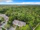Condo building surrounded by green trees, an aerial view at 5003 Laguna Bay Cir # 16, Kissimmee, FL 34746