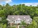 Aerial view of a condo building nestled in a lush, wooded area at 5003 Laguna Bay Cir # 16, Kissimmee, FL 34746