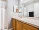 Clean bathroom with shower, wood cabinets, and a vanity at 5003 Laguna Bay Cir # 16, Kissimmee, FL 34746