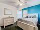 Bedroom features a white dresser and ceiling fan with teal wall at 5003 Laguna Bay Cir # 16, Kissimmee, FL 34746