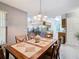 Dining area with wood table and chairs, open to living room at 5003 Laguna Bay Cir # 16, Kissimmee, FL 34746