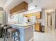 Kitchen with light wood cabinets, a breakfast bar, and tiled floors at 5003 Laguna Bay Cir # 16, Kissimmee, FL 34746