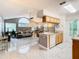 Kitchen with breakfast bar, wood cabinets, and open living room view at 5003 Laguna Bay Cir # 16, Kissimmee, FL 34746