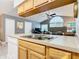 Bright kitchen with wood cabinets, white appliances, and a double sink at 5003 Laguna Bay Cir # 16, Kissimmee, FL 34746