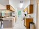 View of kitchen with wood cabinets, white appliances, and an island at 5003 Laguna Bay Cir # 16, Kissimmee, FL 34746