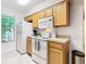Kitchen features wood cabinets, white appliances, and a microwave at 5003 Laguna Bay Cir # 16, Kissimmee, FL 34746