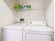 Laundry room with washer, dryer, and shelving at 5003 Laguna Bay Cir # 16, Kissimmee, FL 34746