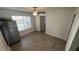 Cozy bedroom with wood-look floors and window with blinds at 5587 Devonbriar Way # 104, Orlando, FL 32822