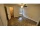 Bright bedroom with wood-look tile floors and ceiling fan at 5587 Devonbriar Way # 104, Orlando, FL 32822
