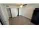 Well-lit bedroom featuring wood-look floors and dual closets at 5587 Devonbriar Way # 104, Orlando, FL 32822