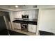 Modern kitchen with white cabinets, granite counters and appliances at 5587 Devonbriar Way # 104, Orlando, FL 32822