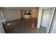Open living room with wood-look floors and kitchen view at 5587 Devonbriar Way # 104, Orlando, FL 32822