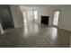Spacious living room with updated flooring, a fireplace, and plenty of natural light from multiple windows at 5587 Devonbriar Way # 104, Orlando, FL 32822