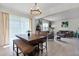 Casual dining area with wooden table and chairs, open to the living room at 673 Blackstone St, Minneola, FL 34715