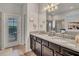 Double vanity bathroom with granite countertops and access to the backyard at 8857 Rhodes St, Kissimmee, FL 34747
