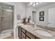 Double vanity bathroom with granite countertop and shower at 8857 Rhodes St, Kissimmee, FL 34747