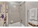 Bathroom with tub shower, tile surround, and updated vanity at 8857 Rhodes St, Kissimmee, FL 34747