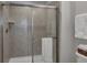 Shower with glass enclosure and neutral tile at 8857 Rhodes St, Kissimmee, FL 34747