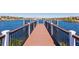 Wooden community dock extending over a calm lake at 8857 Rhodes St, Kissimmee, FL 34747