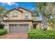 Two-story house with a neutral color scheme and a brick driveway at 8857 Rhodes St, Kissimmee, FL 34747