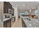 Modern kitchen with dark cabinets, granite counters and island at 8857 Rhodes St, Kissimmee, FL 34747