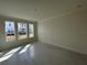 A bedroom featuring three windows that allow ample sunlight and views of the neighborhood at 9819 Gobat Aly, Orlando, FL 32827