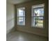 Bright bedroom features large windows, filling the space with natural light and neighborhood views at 9819 Gobat Aly, Orlando, FL 32827