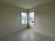 Bright, airy bedroom with light walls, modern tile flooring, and a large double window at 9819 Gobat Aly, Orlando, FL 32827