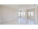 Bright bedroom featuring white walls, base trim, and windows offering neighborhood views at 9819 Gobat Aly, Orlando, FL 32827