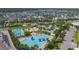Aerial view showcases the community pool area with lap pools, lounge areas, and lush landscaping at 9819 Gobat Aly, Orlando, FL 32827