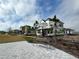 Exterior view of a home with a manicured lawn, bench, and sidewalks at 9819 Gobat Aly, Orlando, FL 32827