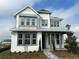 Beautiful two-story home featuring a modern farmhouse facade, landscaped yard and inviting walkway at 9819 Gobat Aly, Orlando, FL 32827