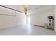 Spacious garage with white walls, epoxy floor, and water heater, offering ample storage and utility at 9819 Gobat Aly, Orlando, FL 32827