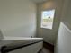 Hallway features hardwood stairs, white walls and trim, and a window offering bright light at 9819 Gobat Aly, Orlando, FL 32827