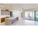 A stylish kitchen island with stainless steel appliances and a large sliding glass door to the outside patio at 9819 Gobat Aly, Orlando, FL 32827