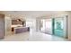 A modern kitchen is featured with an island and sliding doors to an outdoor patio at 9819 Gobat Aly, Orlando, FL 32827