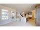 Spacious kitchen with island, modern appliances, and an adjacent dining area and staircase at 9819 Gobat Aly, Orlando, FL 32827