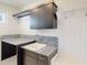 A well-organized laundry room featuring granite countertops, ample cabinetry, and a built-in sink at 9819 Gobat Aly, Orlando, FL 32827