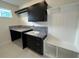 Well-equipped laundry room with sleek cabinetry, granite countertops, and a functional design at 9819 Gobat Aly, Orlando, FL 32827