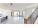 Bright and airy living room with sliding glass doors leading to an outdoor space and staircase at 9819 Gobat Aly, Orlando, FL 32827